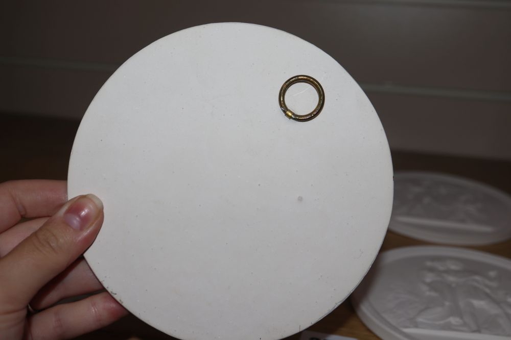 A set of four classical plaster wall plaques, diameter 13.5cm